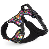 Side-angle view of a vibrant, multicolored floral pattern padded dog harness showing the top control handle and black mesh lining.