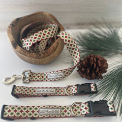 Holiday-themed Lucky Love Dog collar and leash set displayed with pine decor.