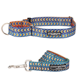 A vibrant martingale dog collar featuring a geometric diamond pattern in shades of navy, turquoise, and sunset orange.