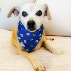Hippie bandana for dogs featuring a blue retro peace sign pattern on a small tan and white dog lying down, displayed next to product information.