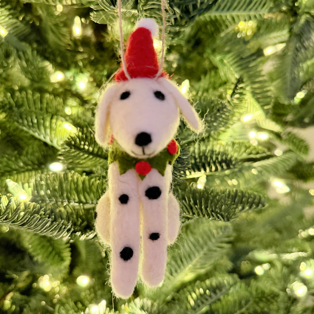 Felt Dalmatian dog Christmas ornament hanging on a tree with a red Santa hat and green collar