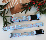 Lucky Love Dog blue collars arranged with Christmas greenery.