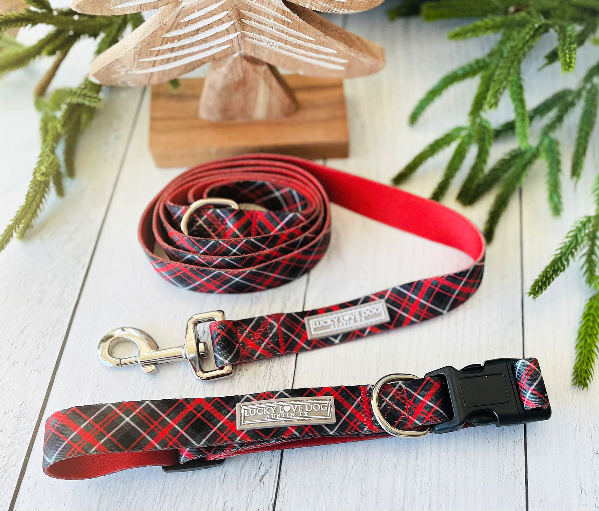 Lucky Love Dog red plaid collar and leash displayed with holiday decor.